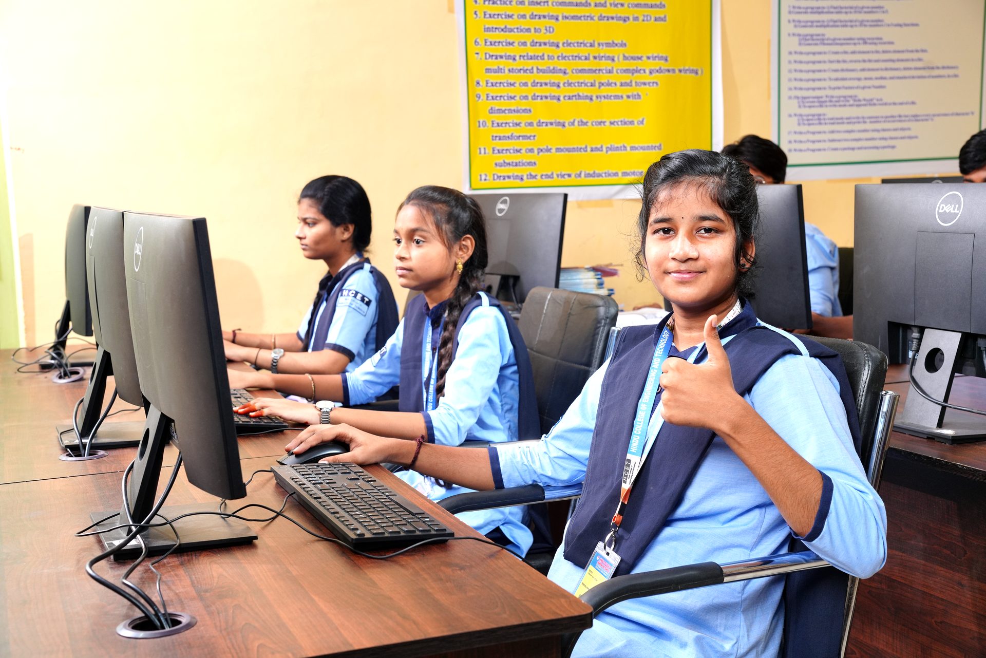 A student smiling while working in the computer lab